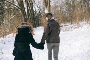 beautiful couple walking in the forest photo