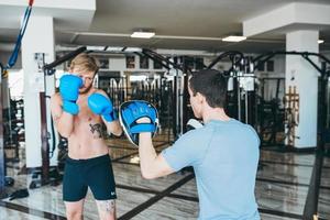 Men practicing boxing in gym photo