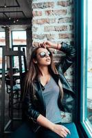 Beautiful girl in sunglasses posing on camera photo