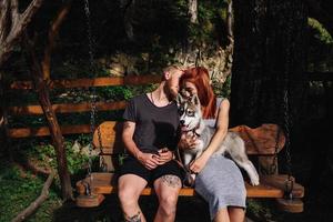 hermosa pareja junto con un perro en un columpio foto