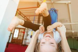 Mom and daughter together perform different exercises photo