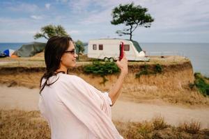 Beautiful, young girl posing on a wild seashore photo