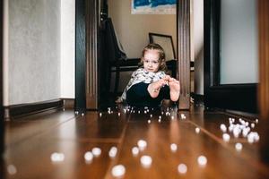 Little girl is playing with foam balls photo