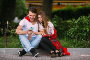 Beautiful young couple relaxing in the park photo