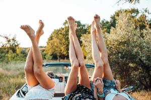 Three girls are lying on the trunk photo