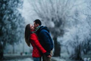 man carries his girlfriend on back photo