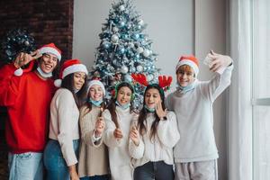 Multi-ethnic young people celebrating New year eve holding sparklers photo