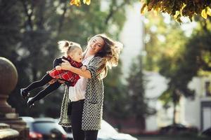 Mother and little daughter playing in a park photo