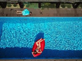 Woman is swimming on an inflatable lounger photo