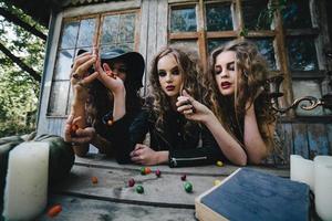 Three vintage witches perform magic ritual photo