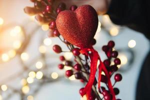 girl holding a red heart in the hands photo