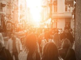 Unrecognizable mass of people walking in the city photo