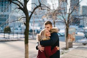 Young smiling happy european couple hugging in winter photo