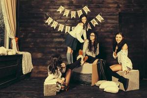 Four charming model posing on a vintage New Year's background photo