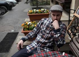 The man in the authentic boots and selvedge jeans  sitting at the table photo