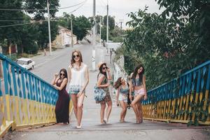 Five young beautiful girls in the city photo