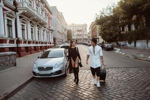 A young, sexy couple of lovers pose for a camera on the streets photo