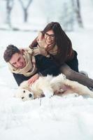 Young couple having fun in winter park photo