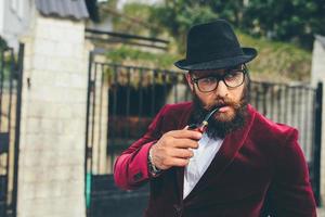 rich man with a beard smokes cradle photo