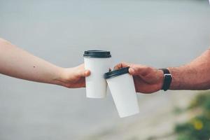 cheers using two cups of coffee photo