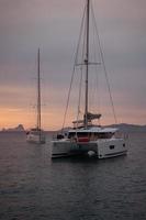 Aerial view from drone on catamaran shipping in sea, sunset photo