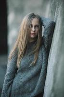 Fashion girl posing against wall photo