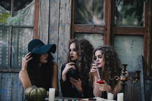 Three vintage witches perform magic ritual photo