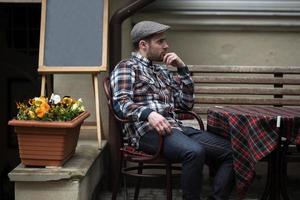 The man in the authentic boots and selvedge jeans  sitting at the table photo