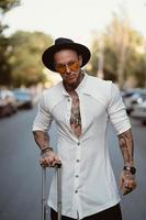 A charismatic young man poses on a camera in the street photo