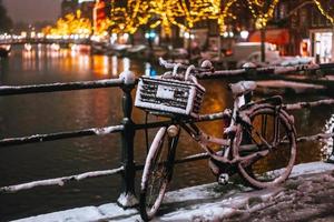 bicicletas estacionadas a lo largo de un puente sobre los canales de amsterdam foto