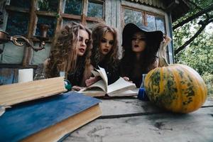 Three vintage witches perform magic ritual photo