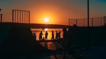 la gente descansa en un campo deportivo junto a la orilla del río foto