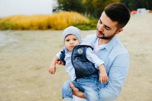 Dad with little son in her arms photo