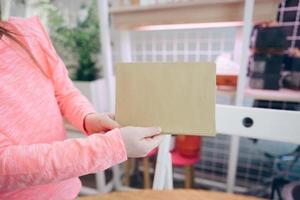 Child showing paper sheet for sales advertisement, copy space. photo