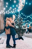 Outdoor close up portrait of young beautiful couple posing on street. photo