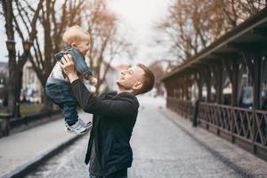 Dad is holding a son in his arms photo