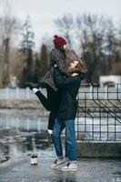 beautiful couple having fun on the pier photo