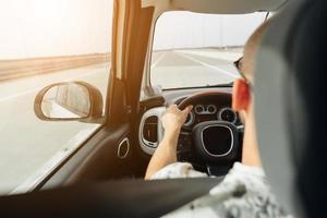 The man in the car traveling on the road photo