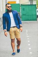 Stylish bearded man walks through the city photo