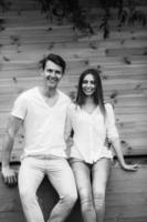 couple posing on a background of the wooden wall photo