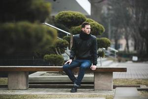 Man in jeans and black jacket photo