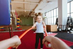 Little girl and mom doing exercises with sticks photo