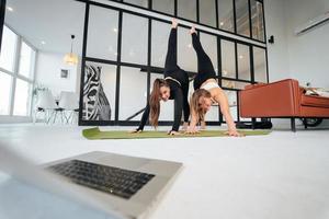 Two charming sports women, do yoga poses, exercises at home photo