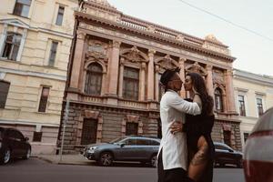 A young, sexy couple of lovers pose for a camera on the streets photo