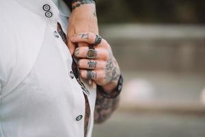 A man holds a woman's hand on his torso photo