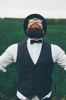 man with a beard, thinking in the field photo