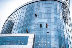 Workers washing windows in the office building photo