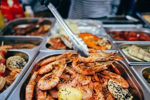 tray with many fried shrimp in the street restaurant photo