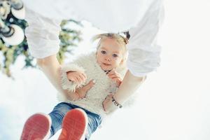 Mother and little daughter playing in a park photo