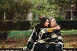 two beautiful in the park, posing for the camera photo